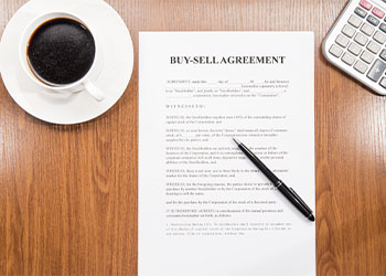 Buy sell agreement paper on table