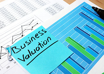 Piece of paper with words business valuation and financial data